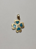 Gold pendant with blue stones on a gray background