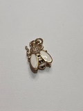 Small gold and black bee charm on a white background