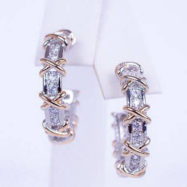 Pair of diamond hoop earrings on a white background