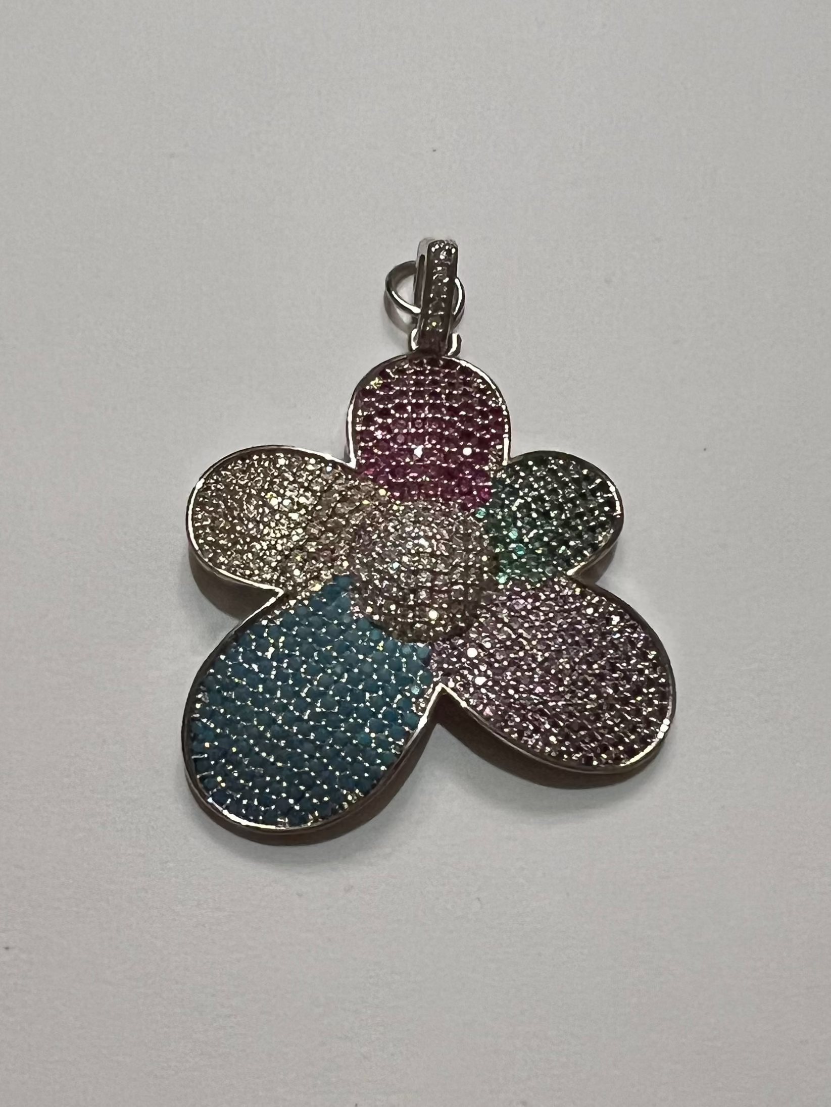 Multicolored flower-shaped pendant on a white background