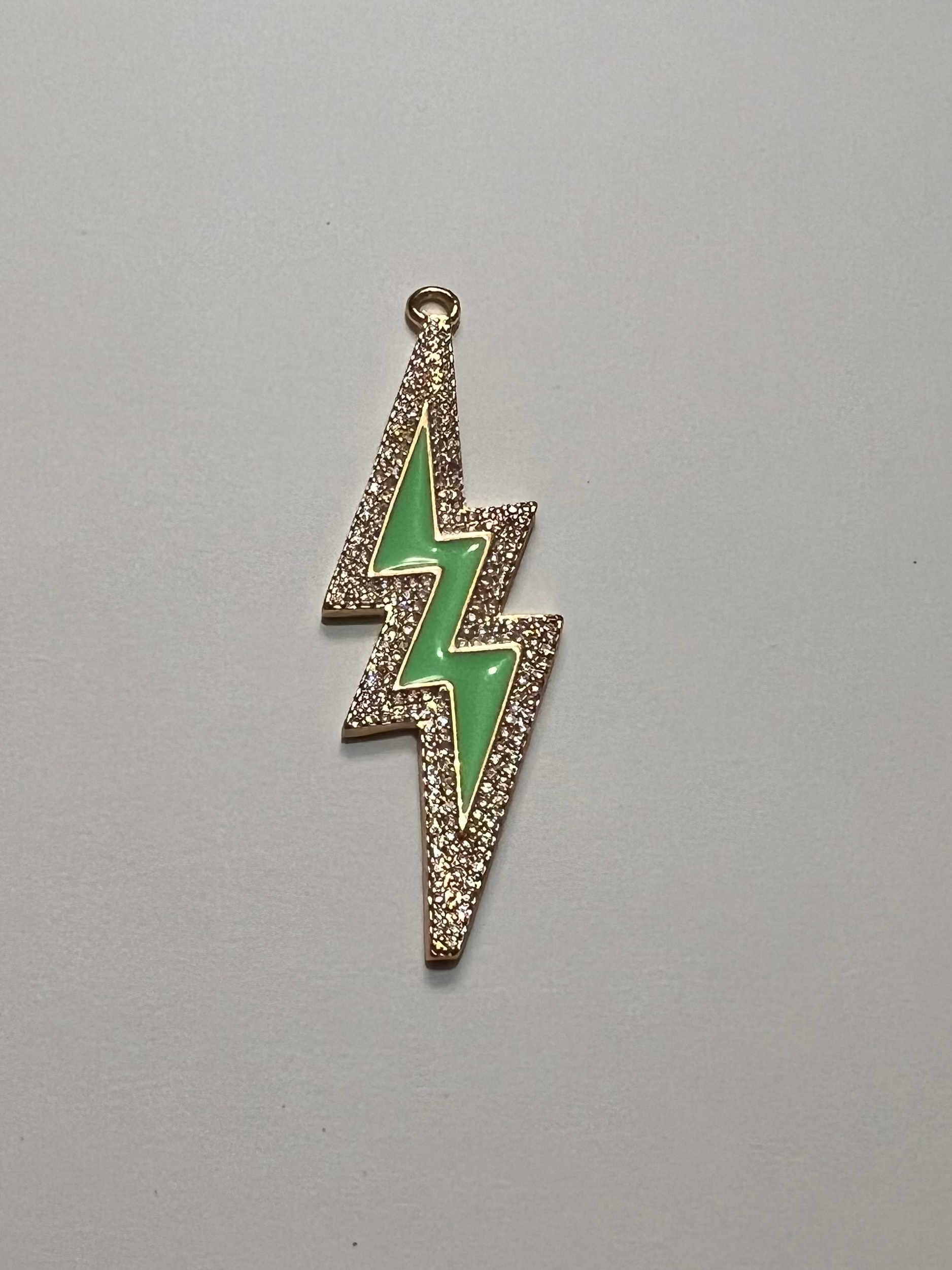 Green lightning bolt pendant on a gray background