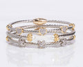 Stack of silver and gold bracelets with heart and star designs on a white background