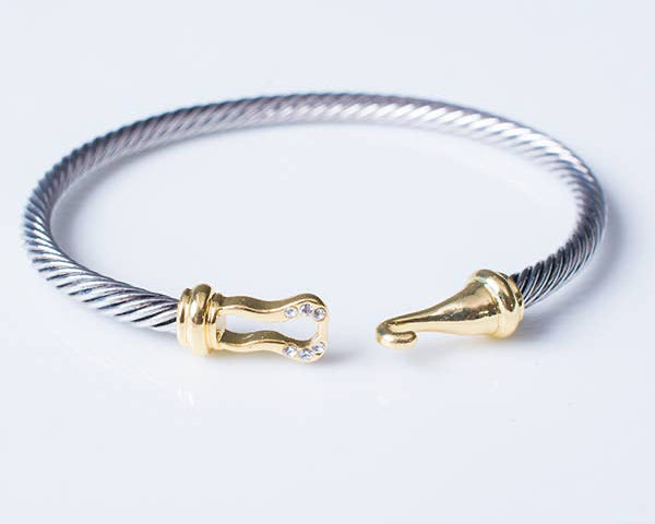 Bracelet with gold clasp on a light gray background